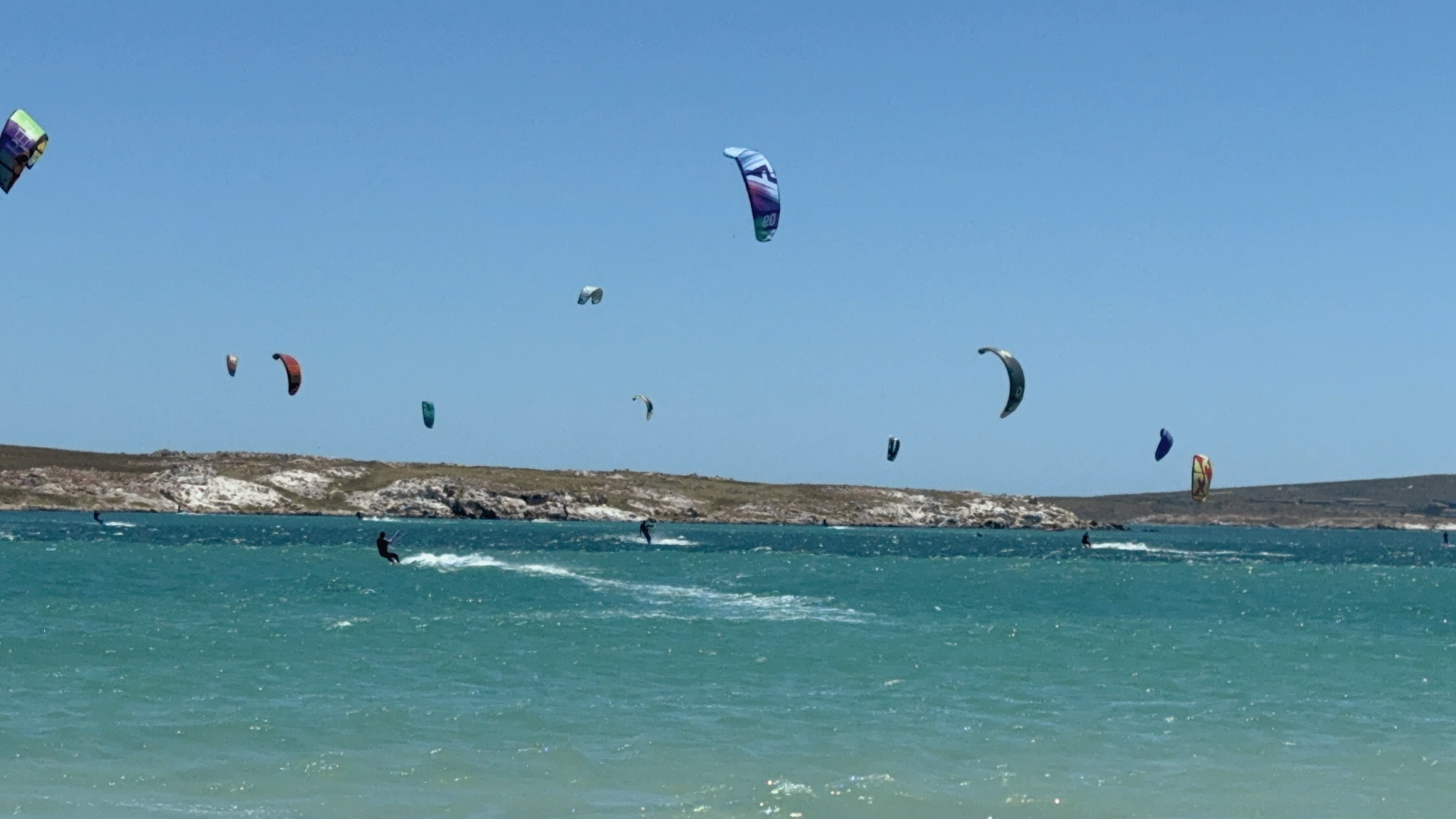 Kitesurfers filling Langebaan lagoon on a windy day