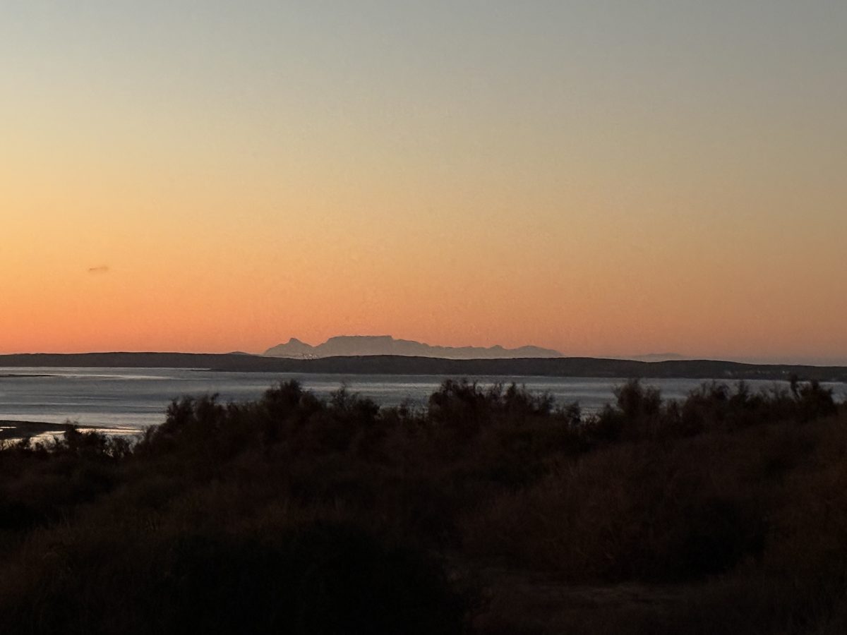 Spectacular sunrise over Langebaan Lagoon with Table Mountain silhouetted on the horizon, 10 March 2026